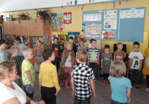 Dzieci śpiewają i inscenizują piosenkę o jesieni