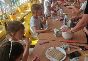 Dzieci z grupy VI przy stole robią deser
