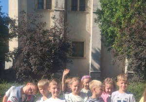 Dzieci stoją na tle zamku