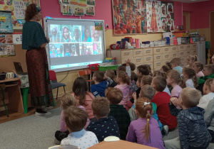 Prowadząca pokazuje dzieciom na tablicy hinduskich ludzi