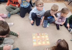 Kikoro dzieci przy planszy z ułożonymi napisami do obrazków